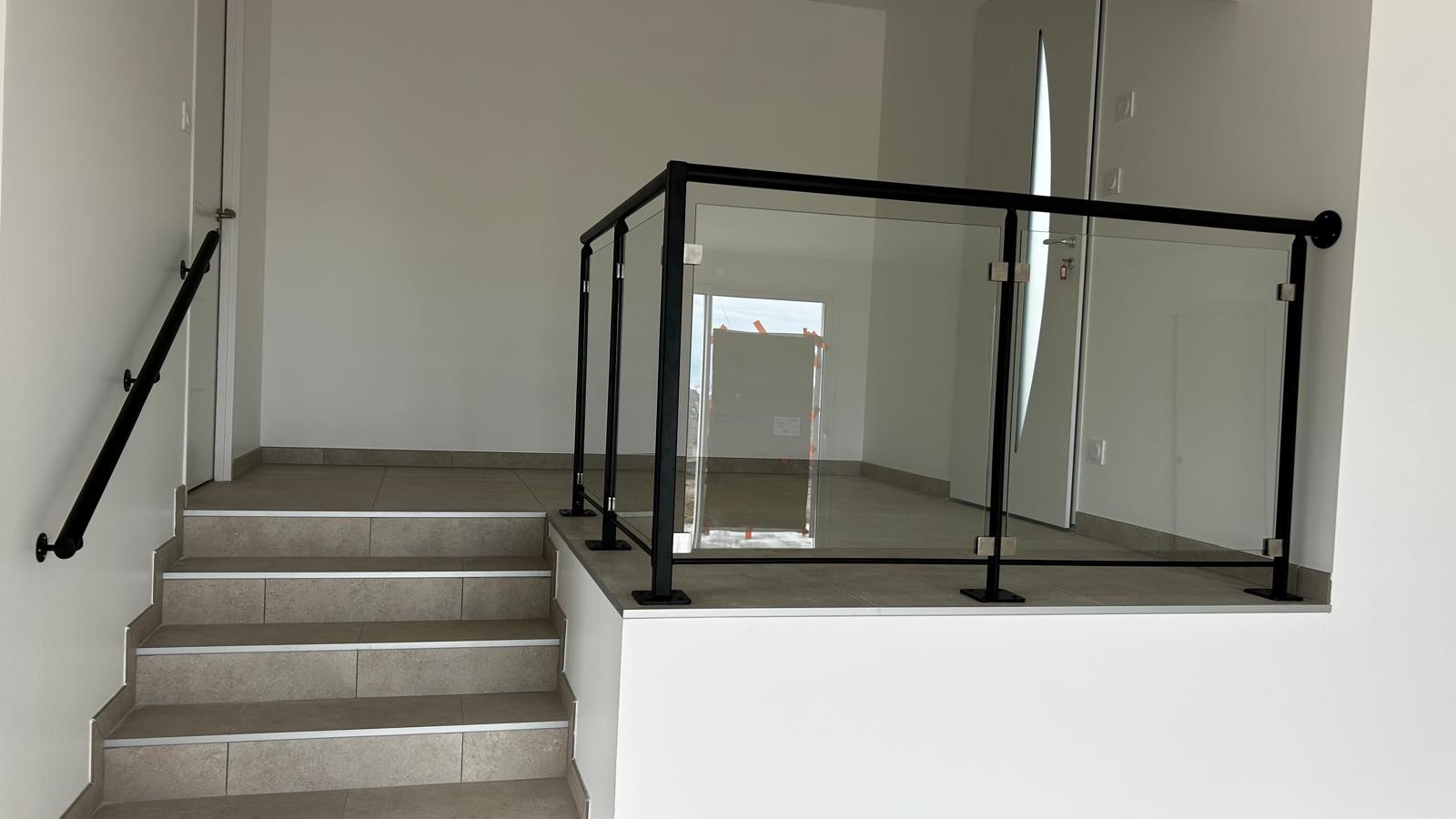 Garde-corps m&eacute;tallique avec vitrage s&eacute;curis&eacute; sur palier int&eacute;rieur et main courante murale sur mesure