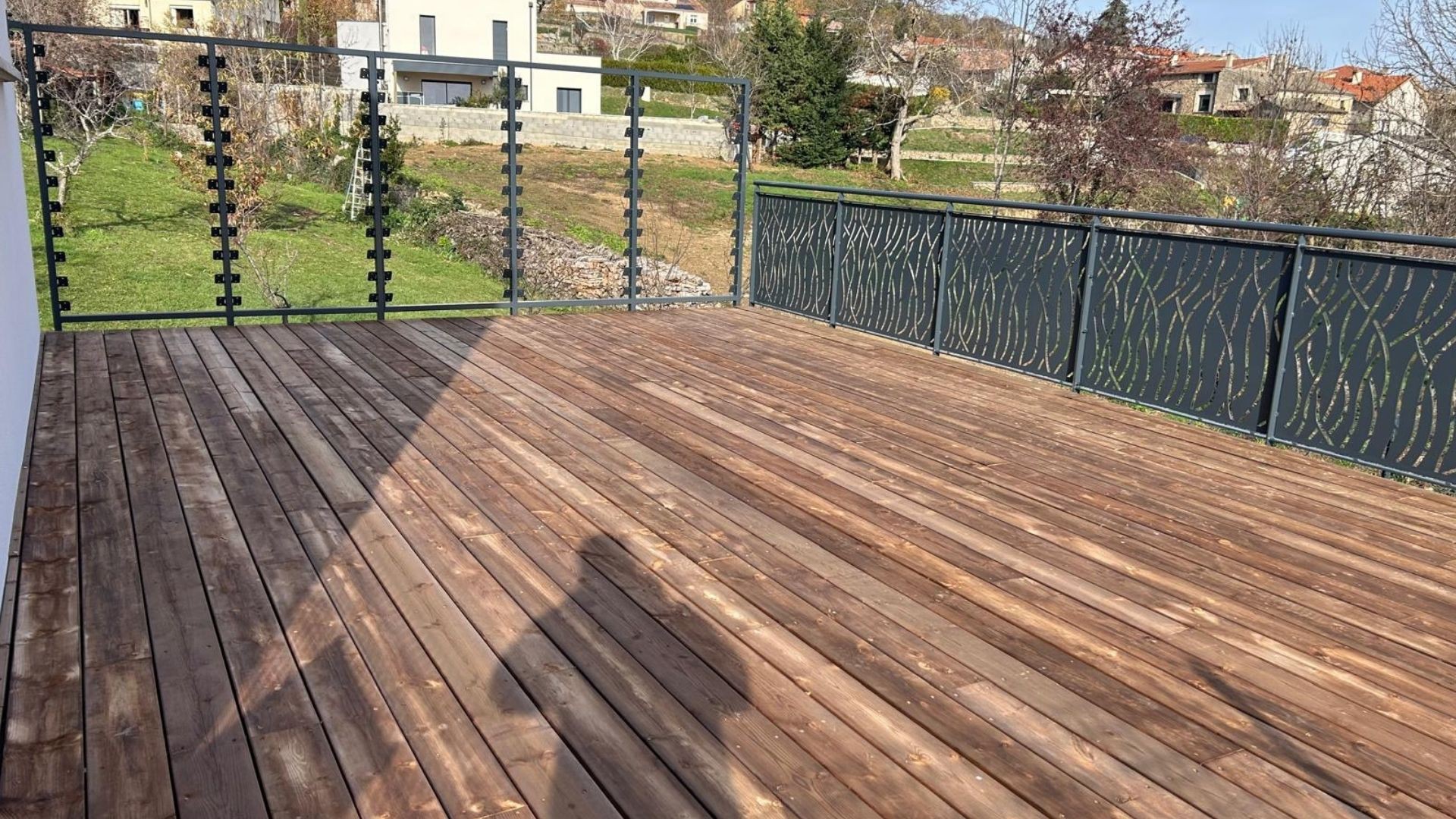 Vue int&eacute;rieure d&rsquo;une terrasse bois &eacute;quip&eacute;e de garde-corps en acier